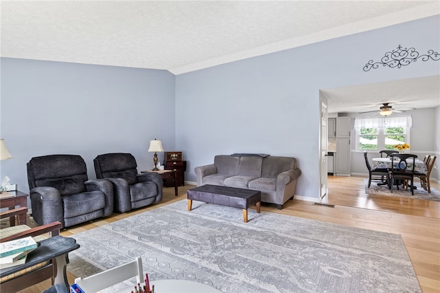 158 Round Pond Ln, Greece, NY 14626 - living area with wood finished floors, ceiling fan, and a textured ceiling