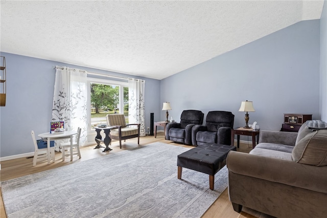 158 Round Pond Ln, Greece, NY 14626 - living area with wood finished floors, a textured ceiling, and lofted ceiling