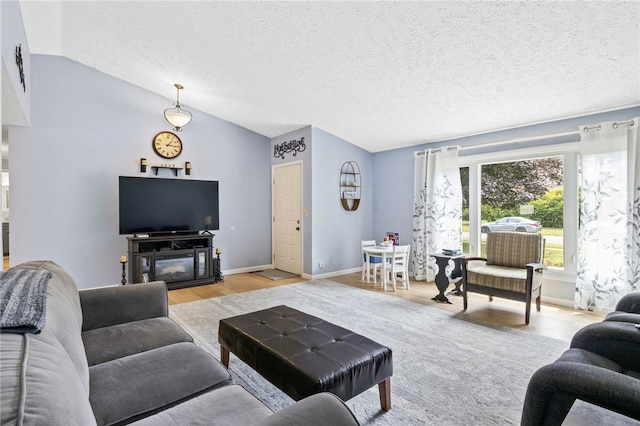158 Round Pond Ln, Greece, NY 14626 - living area with lofted ceiling, light wood-type flooring, and a textured ceiling