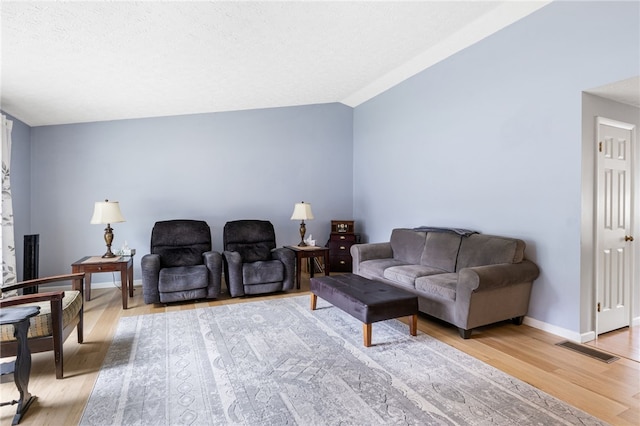 158 Round Pond Ln, Greece, NY 14626 - living area featuring vaulted ceiling and light wood-style floors