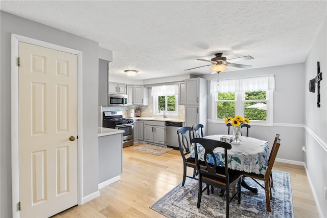 158 Round Pond Ln, Greece, NY 14626 - dining area with light wood-style flooring, ceiling fan, and a textured ceiling