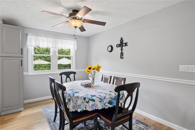 158 Round Pond Ln, Greece, NY 14626 - dining room featuring ceiling fan, a textured ceiling, and light wood-type flooring