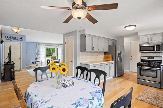 158 Round Pond Ln, Greece, NY 14626 - dining space with a textured ceiling, ceiling fan, and light wood finished floors