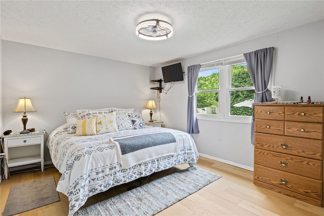 158 Round Pond Ln, Greece, NY 14626 - bedroom featuring wood finished floors and a textured ceiling
