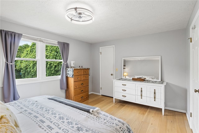 158 Round Pond Ln, Greece, NY 14626 - bedroom featuring light wood-style floors and a textured ceiling
