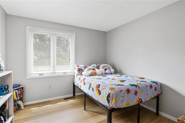 158 Round Pond Ln, Greece, NY 14626 - bedroom featuring light wood-type flooring and multiple windows