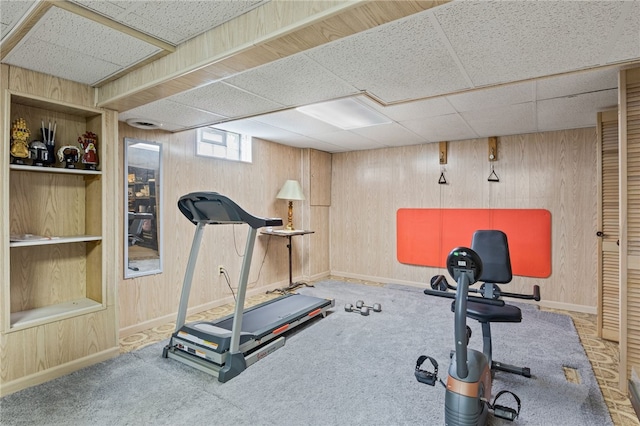 158 Round Pond Ln, Greece, NY 14626 - workout room featuring a drop ceiling, wood walls, and carpet floors