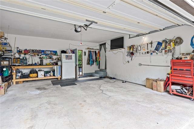 158 Round Pond Ln, Greece, NY 14626 - garage featuring freestanding refrigerator, a workshop area, and a garage door opener
