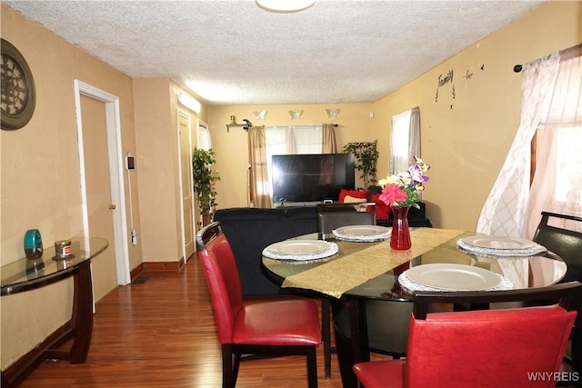 104 Argus St, Buffalo, NY 14207 - dining area featuring wood finished floors and a textured ceiling