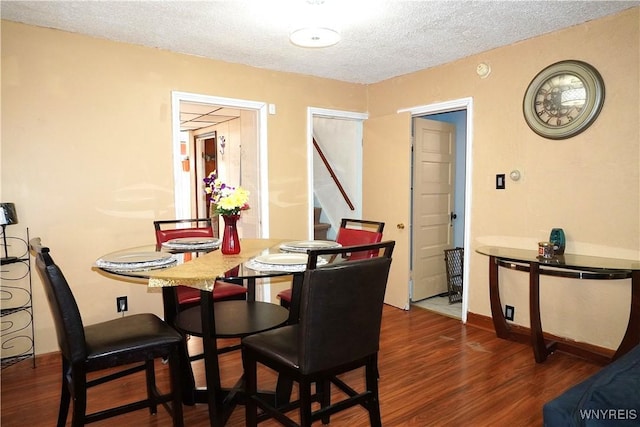 104 Argus St, Buffalo, NY 14207 - dining space with stairs, dark wood-type flooring, and a textured ceiling