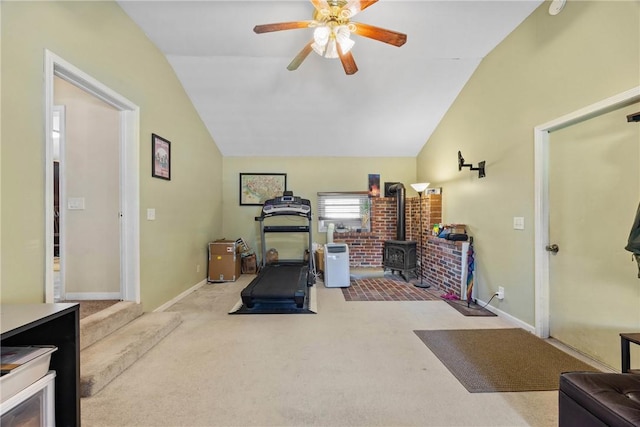 120 Furlong Rd, Brighton, NY 14623 - workout area with vaulted ceiling, a wood stove, ceiling fan, and carpet floors