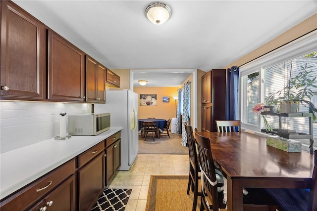 120 Furlong Rd, Brighton, NY 14623 - kitchen featuring light countertops, freestanding refrigerator, light tile patterned floors, backsplash, and light carpet