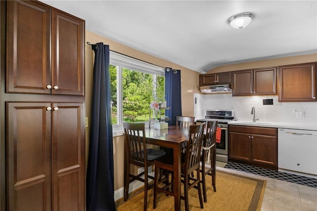 120 Furlong Rd, Brighton, NY 14623 - kitchen featuring white dishwasher, stainless steel gas stove, under cabinet range hood, lofted ceiling, and tasteful backsplash
