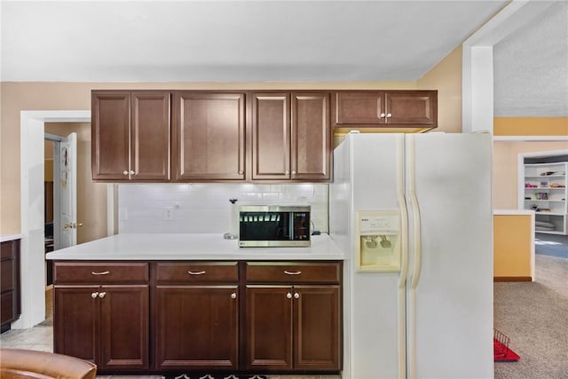 120 Furlong Rd, Brighton, NY 14623 - kitchen featuring white fridge with ice dispenser, light countertops, stainless steel microwave, light colored carpet, and decorative backsplash