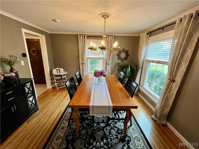 858 Starin Ave, Tonawanda, NY 14223 - dining area featuring a chandelier, plenty of natural light, light wood-type flooring, and crown molding