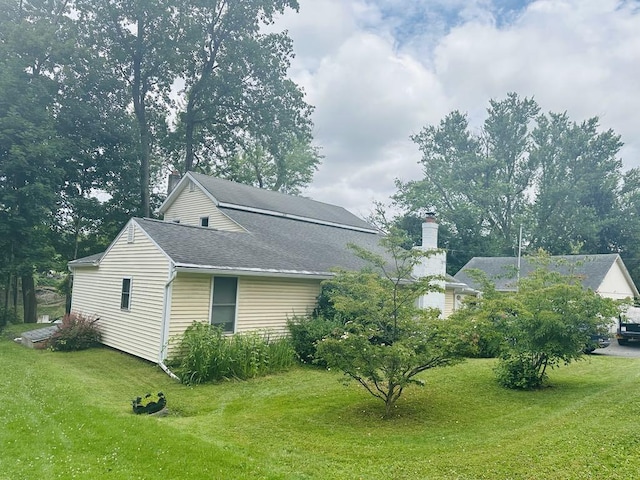 159 County Road 26, Afton, NY 13813 - view of home's exterior featuring a yard, a chimney, and roof with shingles