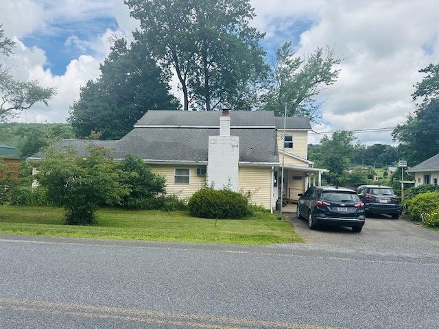 159 County Road 26, Afton, NY 13813 - view of front of house featuring a front lawn, a chimney, and driveway