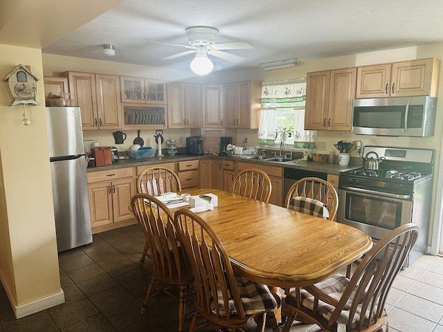 159 County Road 26, Afton, NY 13813 - kitchen featuring appliances with stainless steel finishes, tile patterned flooring, dark countertops, a ceiling fan, and light brown cabinetry