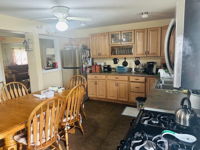 159 County Road 26, Afton, NY 13813 - kitchen with freestanding refrigerator, dark tile patterned flooring, a ceiling fan, glass insert cabinets, and dark countertops