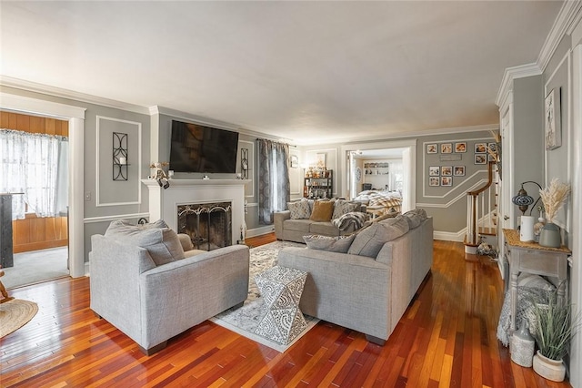 917 W Gray St, Elmira, NY 14905 - living room with stairway, wood-type flooring, crown molding, and a fireplace