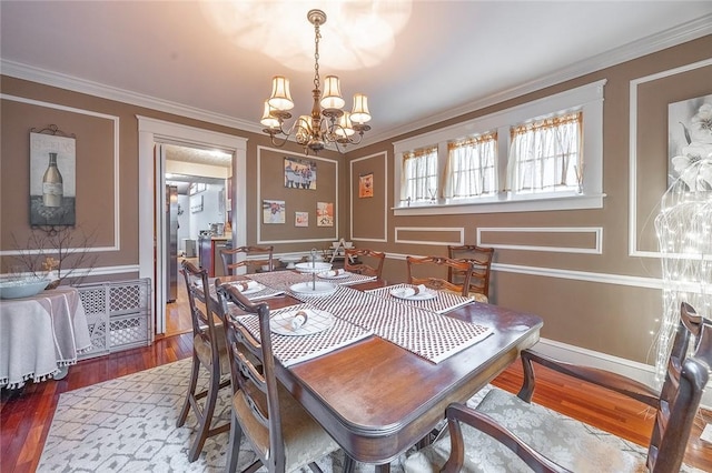 917 W Gray St, Elmira, NY 14905 - dining space with wood finished floors, a chandelier, and ornamental molding