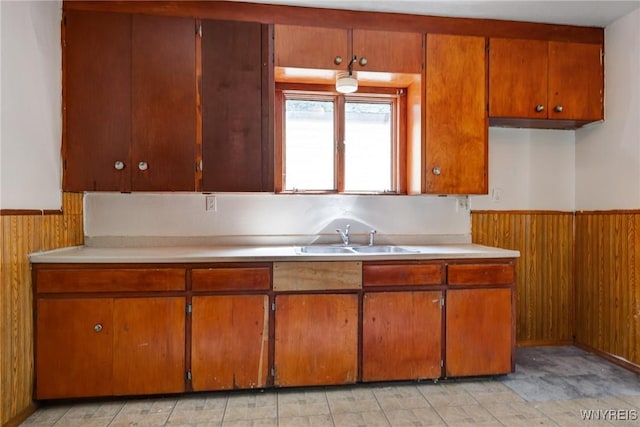 75 Schutrum St, Buffalo, NY 14212 - kitchen with wooden walls, light countertops, wainscoting, and brown cabinetry
