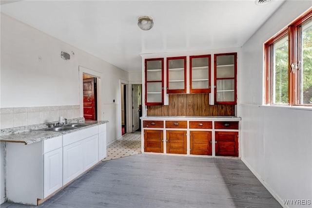 75 Schutrum St, Buffalo, NY 14212 - kitchen featuring glass insert cabinets, light countertops, and light wood-style floors