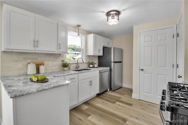101 Kurtz Ave, Lancaster, NY 14086 - kitchen featuring stainless steel appliances, white cabinets, backsplash, light wood-type flooring, and light stone counters