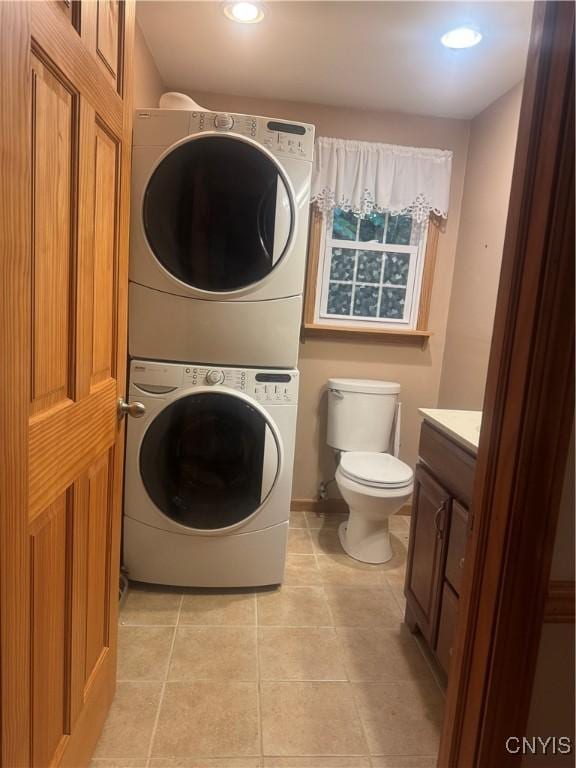 124 N Way, Camillus, NY 13031 - laundry area with estacked washer and dryer, light tile patterned floors, and recessed lighting