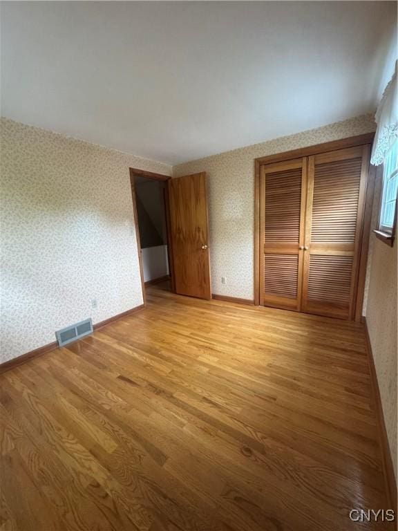 124 N Way, Camillus, NY 13031 - unfurnished bedroom with wallpapered walls and light wood-style floors