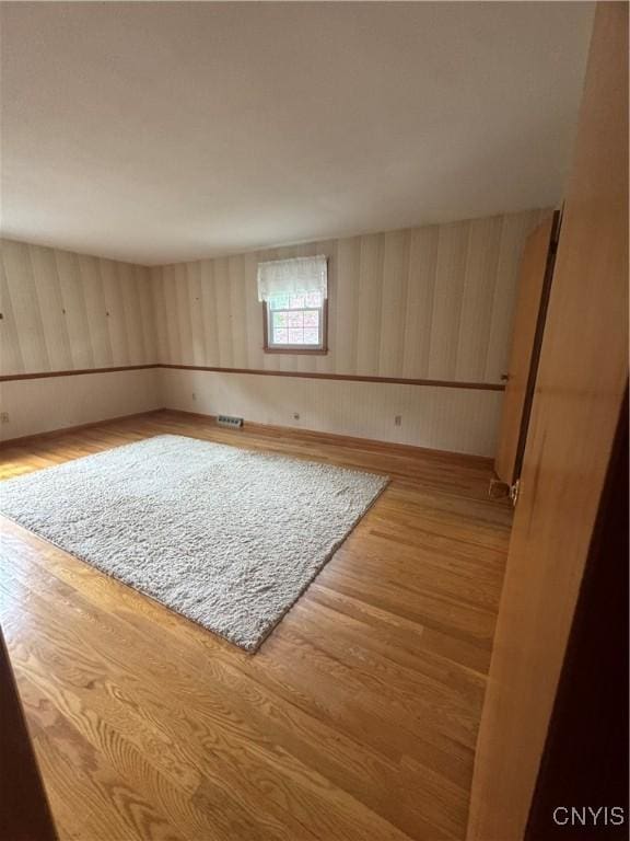 124 N Way, Camillus, NY 13031 - empty room with wood finished floors and wood walls