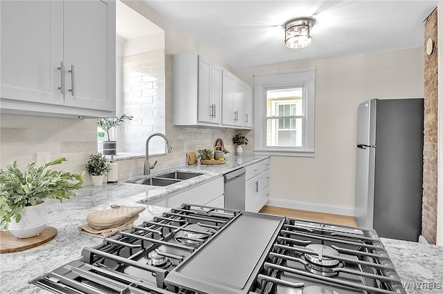 111 Montrose Ave, Buffalo, NY 14214 - kitchen with stainless steel appliances, backsplash, light stone countertops, and white cabinets