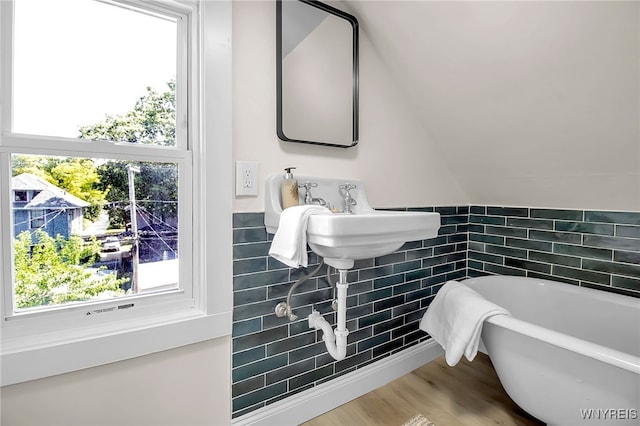 111 Montrose Ave, Buffalo, NY 14214 - bathroom featuring a freestanding tub and wood finished floors