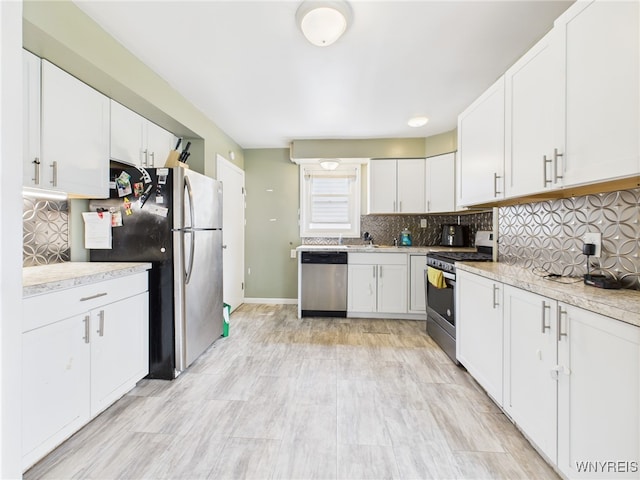 125 Phyllis Ave, Buffalo, NY 14215 - kitchen with appliances with stainless steel finishes, light countertops, decorative backsplash, and white cabinetry