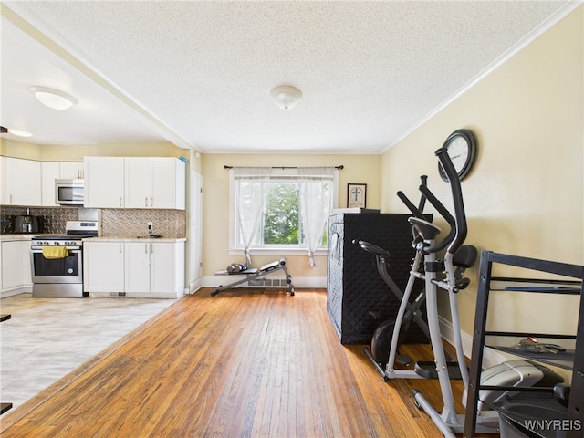 125 Phyllis Ave, Buffalo, NY 14215 - workout area with ornamental molding, light wood-style floors, and a textured ceiling