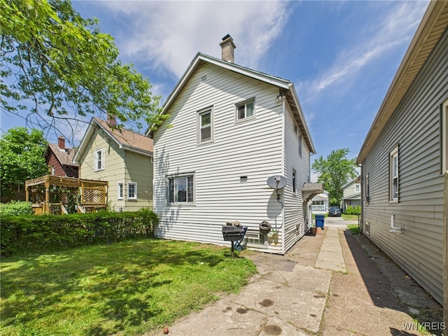 125 Phyllis Ave, Buffalo, NY 14215 - back of house featuring a lawn and a chimney