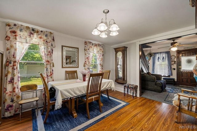 19 Reed St, Lockport City, NY 14094 - dining room featuring a chandelier, crown molding, wood finished floors, and healthy amount of natural light