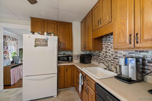 19 Reed St, Lockport City, NY 14094 - kitchen with freestanding refrigerator, stainless steel microwave, brown cabinetry, light countertops, and a drop ceiling