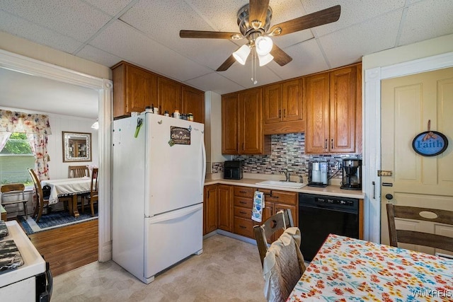 19 Reed St, Lockport City, NY 14094 - kitchen featuring white appliances, light countertops, ceiling fan, brown cabinets, and backsplash