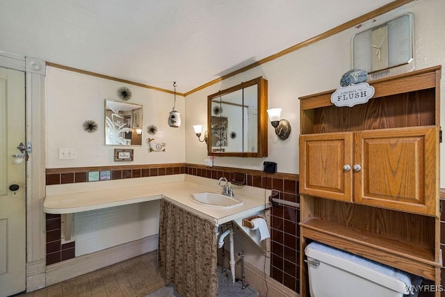 19 Reed St, Lockport City, NY 14094 - bathroom with tile walls, vanity, wainscoting, and crown molding