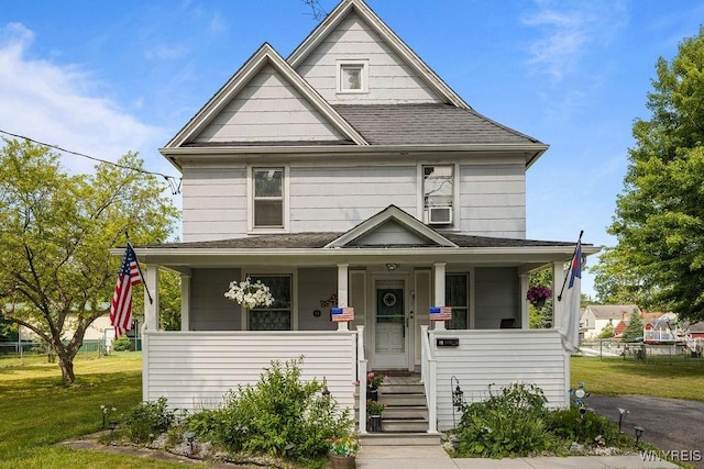 19 Reed St, Lockport City, NY 14094 - view of front of house with covered porch, a shingled roof, and a front lawn