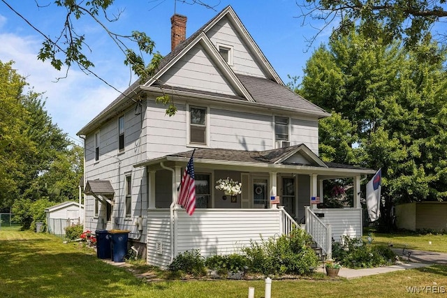 19 Reed St, Lockport City, NY 14094 - american foursquare style home featuring a front lawn, a chimney, a porch, a shingled roof, and stairs