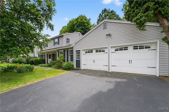 7569 Northfield Ln, Manlius, NY 13104 - traditional-style house featuring driveway, an attached garage, and a front yard