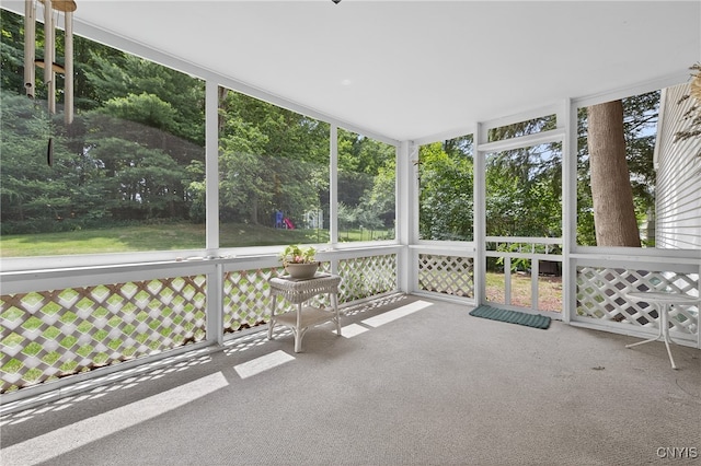 7569 Northfield Ln, Manlius, NY 13104 - unfurnished sunroom with view of wooded area