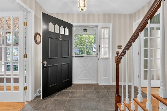 7569 Northfield Ln, Manlius, NY 13104 - entrance foyer featuring wallpapered walls, stairs, and plenty of natural light