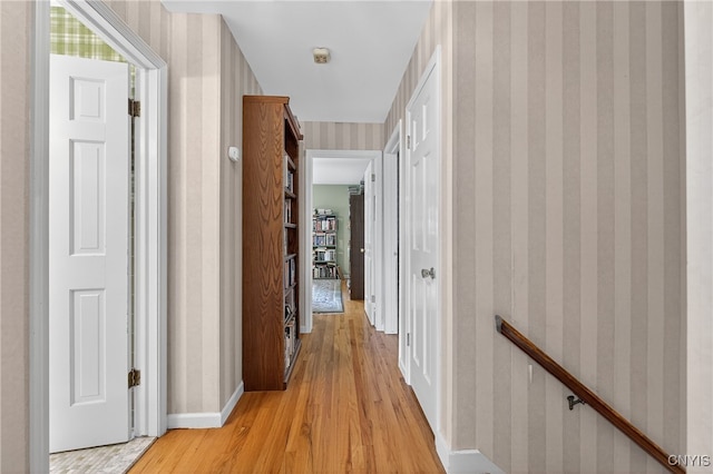 7569 Northfield Ln, Manlius, NY 13104 - hall with wallpapered walls, light wood-style floors, and an upstairs landing