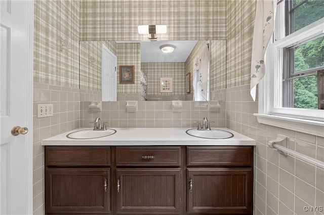 7569 Northfield Ln, Manlius, NY 13104 - full bath featuring double vanity, tile walls, and wallpapered walls