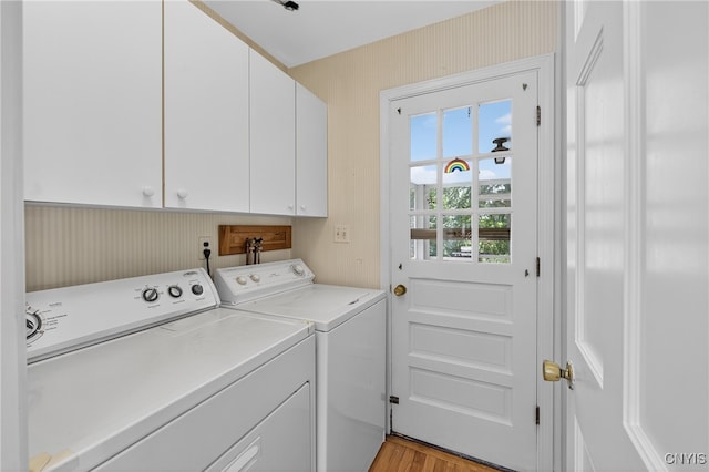 7569 Northfield Ln, Manlius, NY 13104 - laundry area with separate washer and dryer, cabinet space, wallpapered walls, and light wood-style flooring