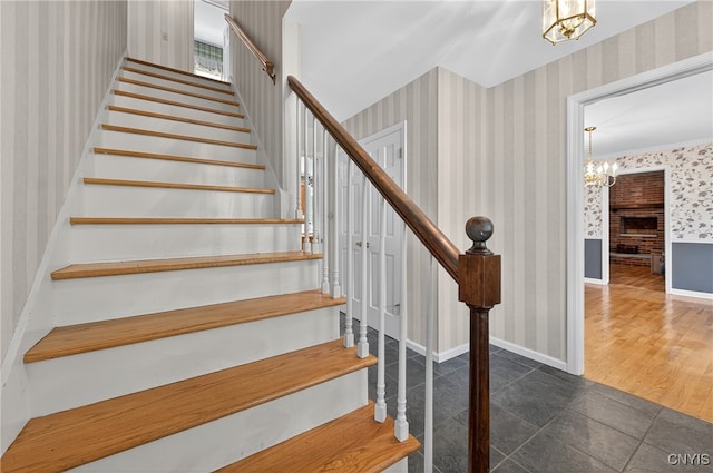 7569 Northfield Ln, Manlius, NY 13104 - stairs with wallpapered walls, a chandelier, and tile patterned flooring