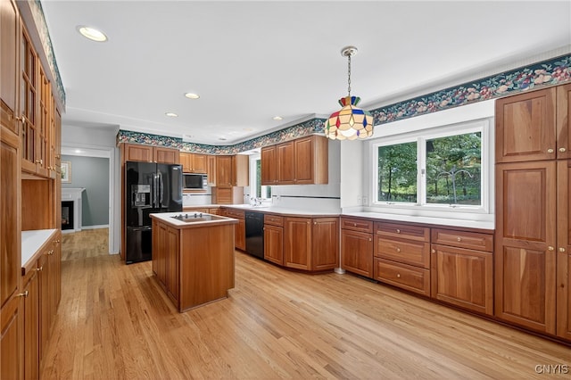 7569 Northfield Ln, Manlius, NY 13104 - kitchen with black appliances, brown cabinetry, light wood-type flooring, a center island, and light countertops